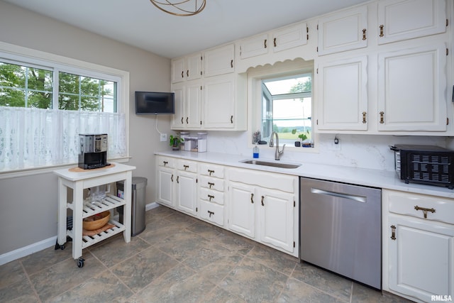 13524 US Route 67, Milan, IL 61264 - kitchen with stainless steel dishwasher, plenty of natural light, stone finish flooring, and white cabinets