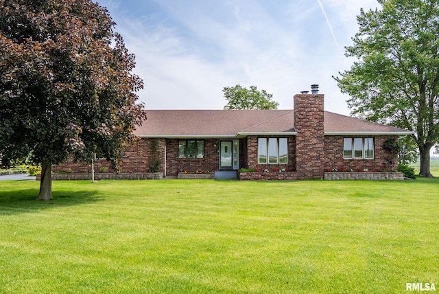 20425 20th Ave, Stockton, IA 52769 - ranch-style home with brick siding, a chimney, a front yard, and a shingled roof