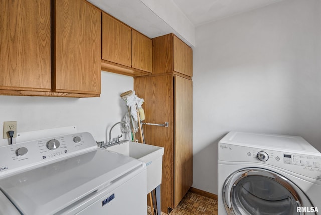 20425 20th Ave, Stockton, IA 52769 - laundry area featuring cabinet space and washer and clothes dryer