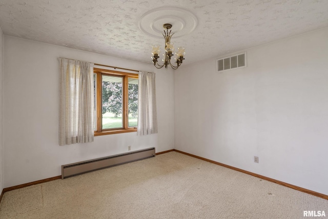 20425 20th Ave, Stockton, IA 52769 - carpeted empty room featuring a baseboard radiator, a chandelier, and a textured ceiling