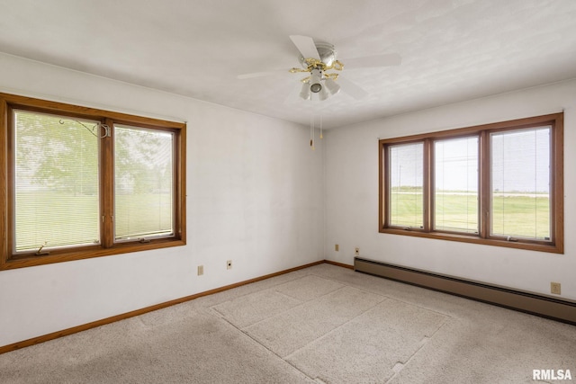 20425 20th Ave, Stockton, IA 52769 - unfurnished room with plenty of natural light, a baseboard heating unit, ceiling fan, and light carpet