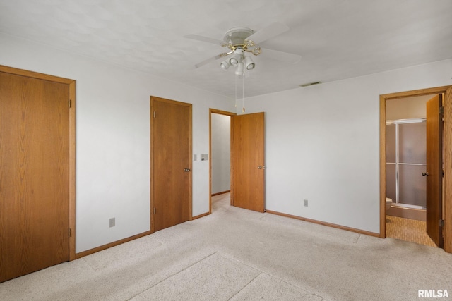 20425 20th Ave, Stockton, IA 52769 - unfurnished bedroom with carpet flooring, connected bathroom, and ceiling fan