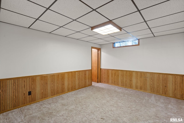 20425 20th Ave, Stockton, IA 52769 - unfurnished room featuring wainscoting, a paneled ceiling, and wood walls