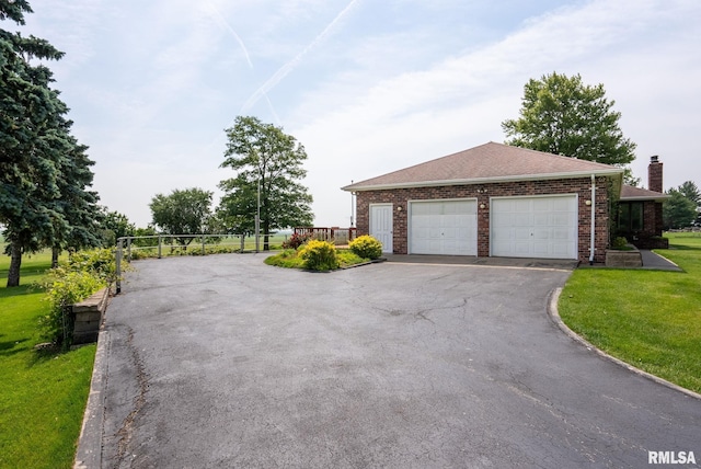 20425 20th Ave, Stockton, IA 52769 - view of front of house with driveway, a front lawn, brick siding, and a chimney