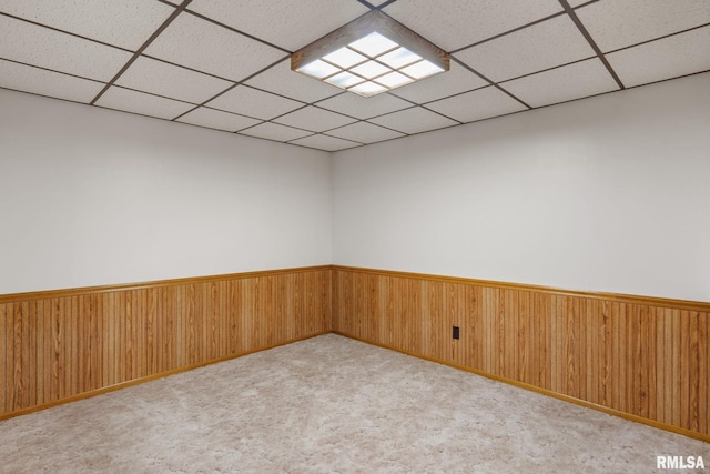 20425 20th Ave, Stockton, IA 52769 - carpeted spare room featuring a paneled ceiling, wainscoting, and wooden walls