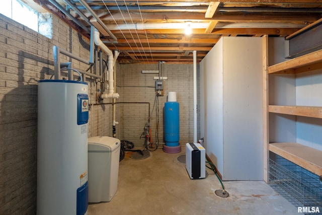 20425 20th Ave, Stockton, IA 52769 - below grade area featuring electric water heater, brick wall, a water softener system, and a water pressure tank