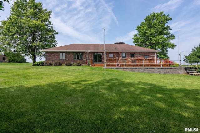 20425 20th Ave, Stockton, IA 52769 - back of property featuring a lawn, brick siding, and a wooden deck