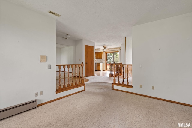 20425 20th Ave, Stockton, IA 52769 - carpeted spare room with a baseboard radiator and a textured ceiling