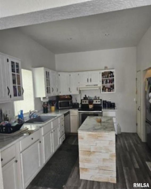 701 3rd St, Seaton, IL 61476 - kitchen featuring appliances with stainless steel finishes, extractor fan, dark wood-type flooring, and white cabinetry