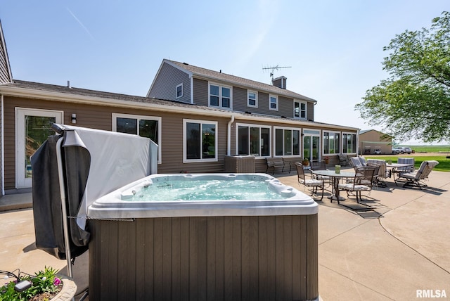 3473 270th St, De Witt, IA 52742 - view of swimming pool featuring a hot tub, a patio area, and outdoor dining area