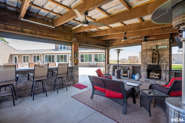 3473 270th St, De Witt, IA 52742 - view of patio / terrace featuring ceiling fan and an outdoor living space with a fireplace