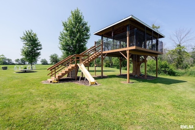 3473 270th St, De Witt, IA 52742 - view of playground with stairway, a lawn, and a deck