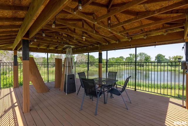 3473 270th St, De Witt, IA 52742 - wooden terrace with a water view and outdoor dining space