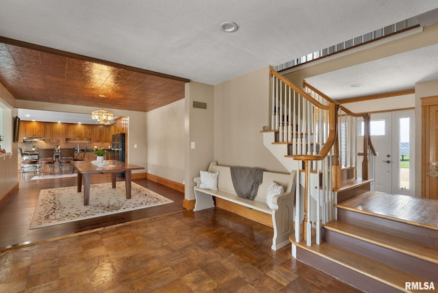 3473 270th St, De Witt, IA 52742 - entrance foyer featuring stairs and a chandelier