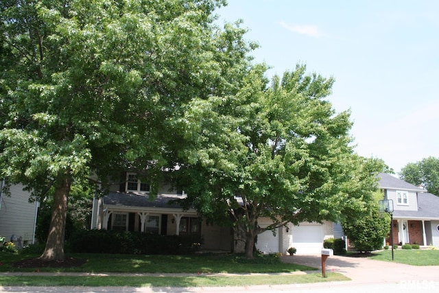 4145 Aspen Hills Dr, Bettendorf, IA 52722 - obstructed view of property with driveway, a front yard, and a garage