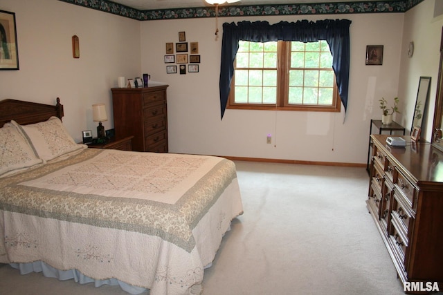 4145 Aspen Hills Dr, Bettendorf, IA 52722 - bedroom with baseboards and light colored carpet