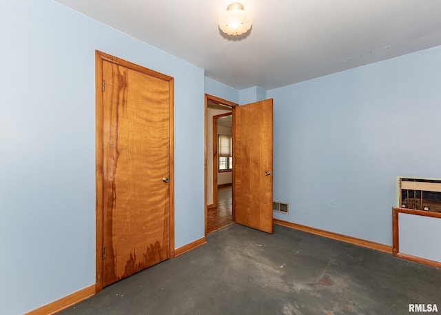430 10th Pl, Camanche, IA 52730 - unfurnished bedroom featuring baseboards and concrete floors