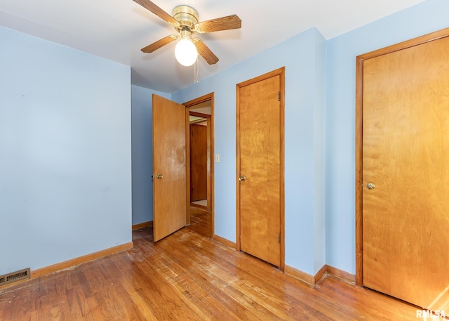 430 10th Pl, Camanche, IA 52730 - unfurnished bedroom with light wood-type flooring and a ceiling fan