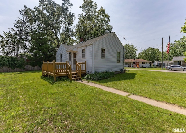 430 10th Pl, Camanche, IA 52730 - rear view of property with a wooden deck and a lawn