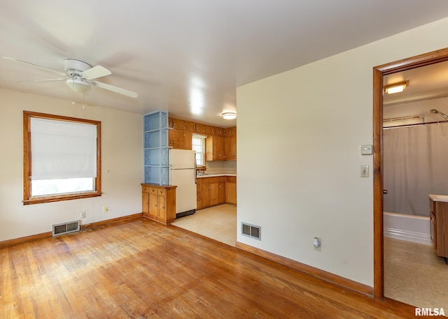 430 10th Pl, Camanche, IA 52730 - unfurnished living room with ceiling fan and light wood-style floors