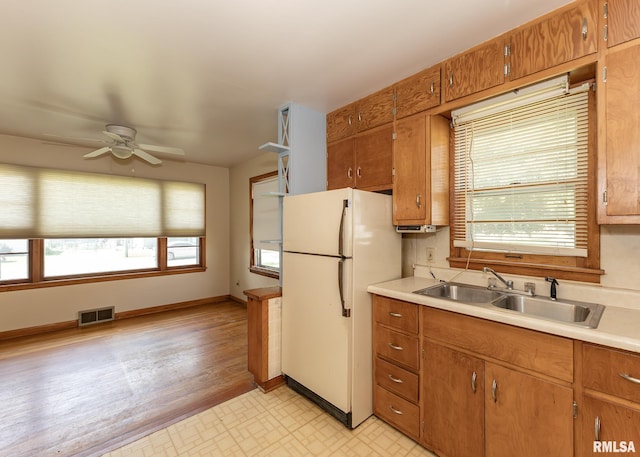 430 10th Pl, Camanche, IA 52730 - kitchen with freestanding refrigerator, light countertops, ceiling fan, and healthy amount of natural light