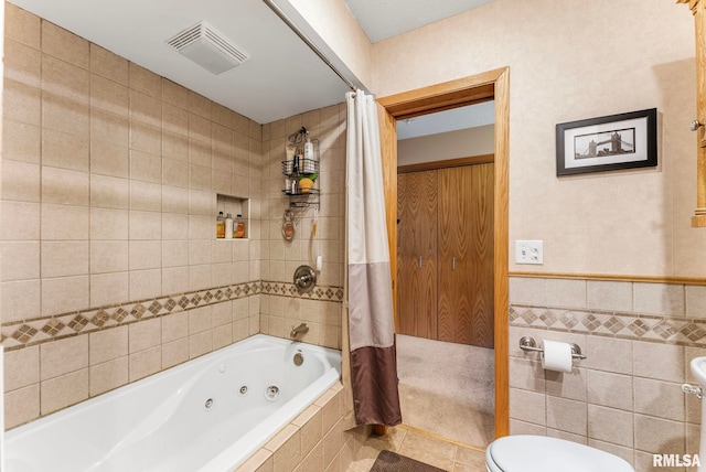 5903 36th Avenue Ct Unit 19, Moline, IL 61265 - full bathroom featuring a combined bath / shower with jetted tub, tile walls, tile patterned floors, and a wainscoted wall