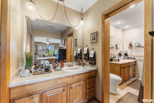 5903 36th Avenue Ct Unit 19, Moline, IL 61265 - full bath with vanity, a ceiling fan, a fireplace, and tile patterned flooring