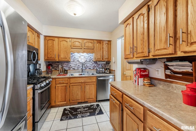 5903 36th Avenue Ct Unit 19, Moline, IL 61265 - kitchen featuring stainless steel appliances, tasteful backsplash, light countertops, light tile patterned floors, and brown cabinets