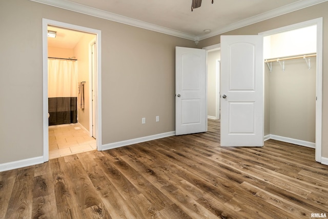 1321 N 7th St, Herrin, IL 62948 - unfurnished bedroom with ornamental molding, wood finished floors, a closet, and ensuite bath