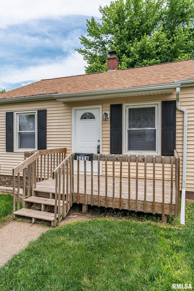 3116 Orchard Ave, Davenport, IA 52802 - single story home featuring a chimney, a front lawn, a wooden deck, and a shingled roof
