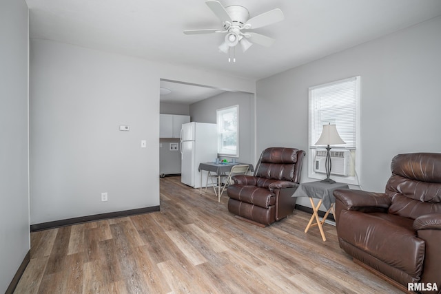 3116 Orchard Ave, Davenport, IA 52802 - living area featuring cooling unit, light wood finished floors, and a ceiling fan