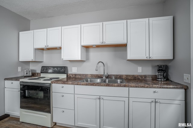 3116 Orchard Ave, Davenport, IA 52802 - kitchen with electric range oven, dark countertops, white cabinetry, and a textured ceiling