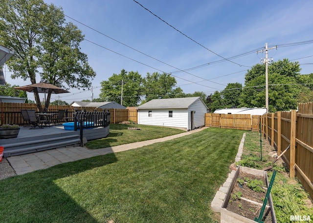 3020 Cleveland St, Clinton, IA 52732 - fenced backyard featuring a vegetable garden, a wooden deck, and outdoor dining area