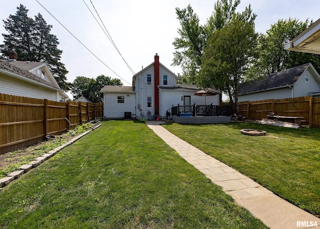 3020 Cleveland St, Clinton, IA 52732 - rear view of property with a fire pit, a fenced backyard, and a wooden deck
