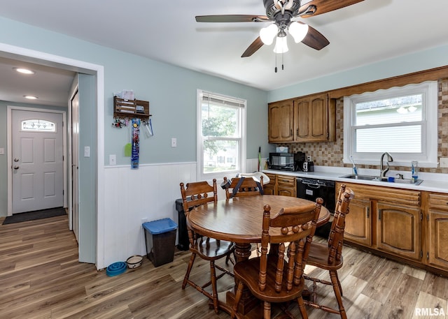 3020 Cleveland St, Clinton, IA 52732 - dining area with wainscoting, light wood-style floors, ceiling fan, and recessed lighting