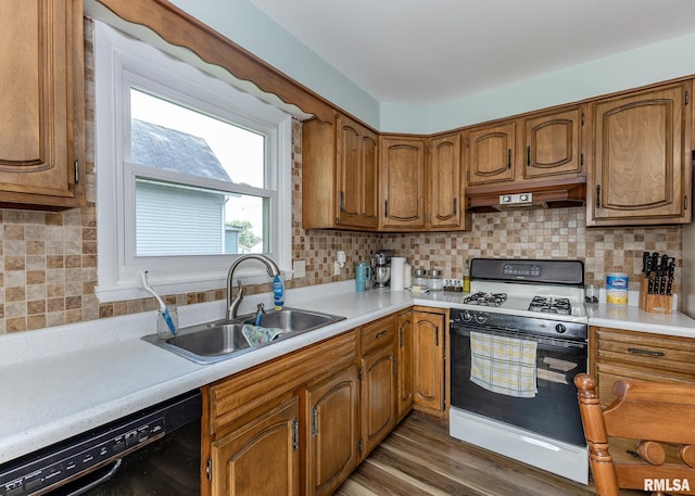 3020 Cleveland St, Clinton, IA 52732 - kitchen featuring gas range, black dishwasher, extractor fan, light countertops, and brown cabinetry