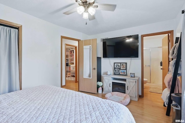 1426 W 48th St, Davenport, IA 52806 - bedroom with light wood-style flooring, ceiling fan, and ensuite bathroom