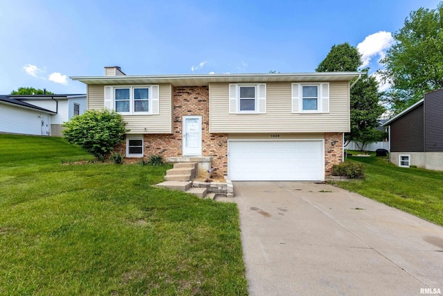 1426 W 48th St, Davenport, IA 52806 - raised ranch with a garage, driveway, a front lawn, and a chimney