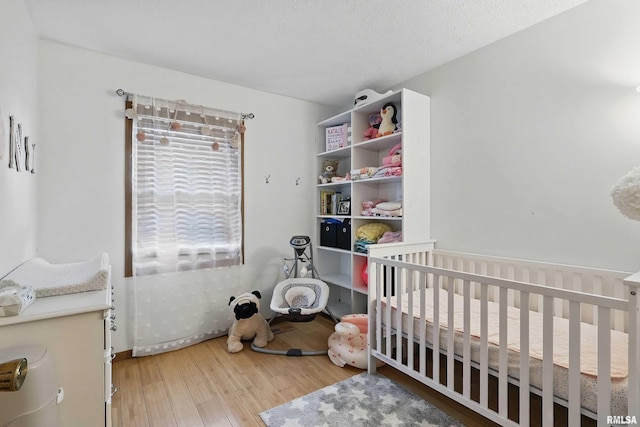 1426 W 48th St, Davenport, IA 52806 - bedroom with hardwood / wood-style floors and a nursery area