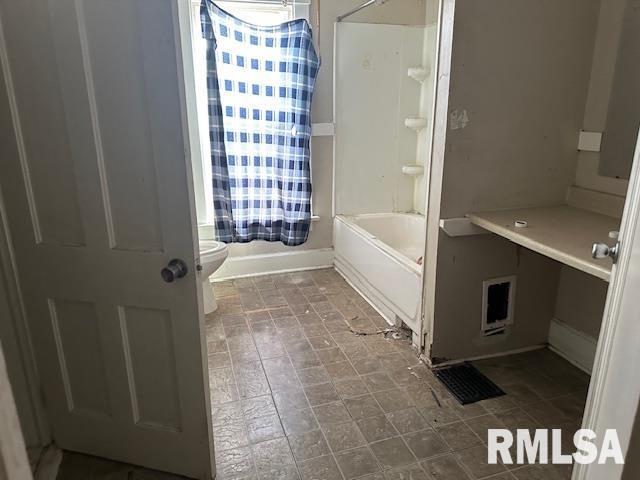 1919 Sturdevant St, Davenport, IA 52804 - bathroom featuring toilet and shower / washtub combination
