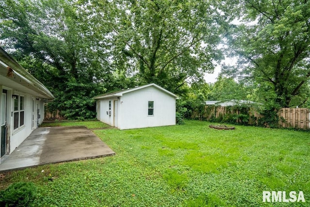1413 Sebring Way, Carbondale, IL 62901 - fenced backyard with a patio area and an outbuilding