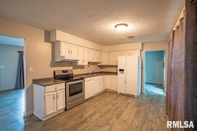 1413 Sebring Way, Carbondale, IL 62901 - kitchen with white appliances, wood finished floors, dark countertops, a textured ceiling, and white cabinetry