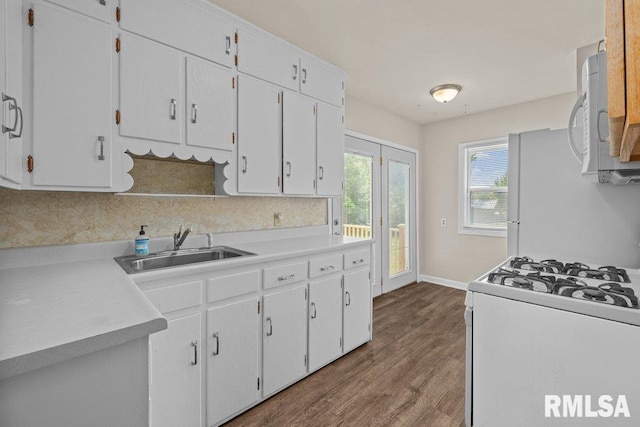 516 19th Ave, Rock Island, IL 61201 - kitchen featuring white appliances, white cabinets, dark wood-type flooring, and light countertops