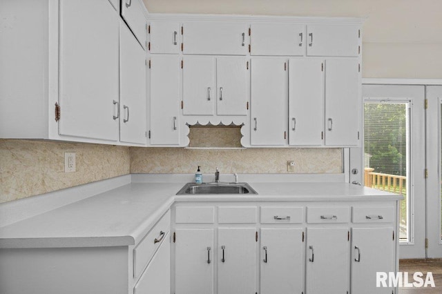 516 19th Ave, Rock Island, IL 61201 - kitchen featuring white cabinets, light countertops, and backsplash