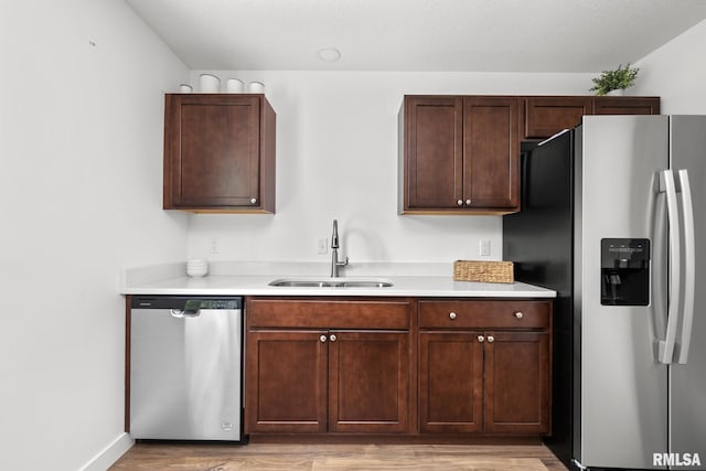 813 Williams Way, Carbon Cliff, IL 61239 - kitchen featuring appliances with stainless steel finishes, light wood-style flooring, light countertops, and dark brown cabinets