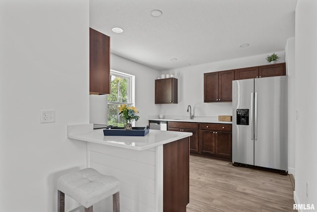 813 Williams Way, Carbon Cliff, IL 61239 - kitchen featuring appliances with stainless steel finishes, light countertops, light wood-style floors, a peninsula, and recessed lighting