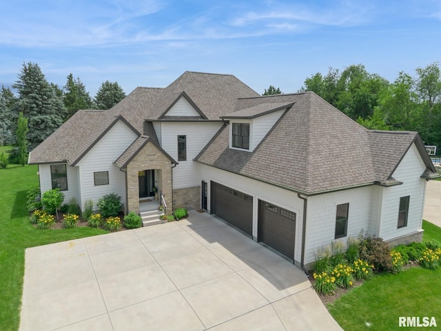 6925 Grover Sta, Bettendorf, IA 52722 - view of front of home with an attached garage, concrete driveway, a shingled roof, a front yard, and stone siding