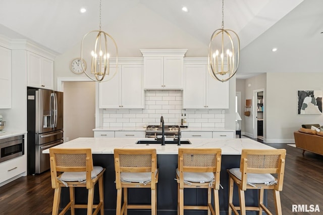 6925 Grover Sta, Bettendorf, IA 52722 - kitchen with stainless steel appliances, a chandelier, lofted ceiling, backsplash, and dark wood finished floors