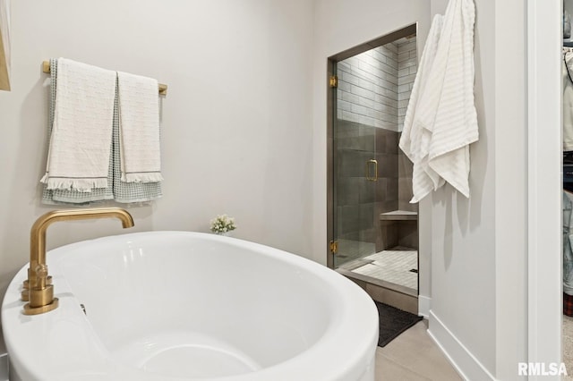 6925 Grover Sta, Bettendorf, IA 52722 - bathroom with a shower stall, a freestanding bath, and tile patterned floors