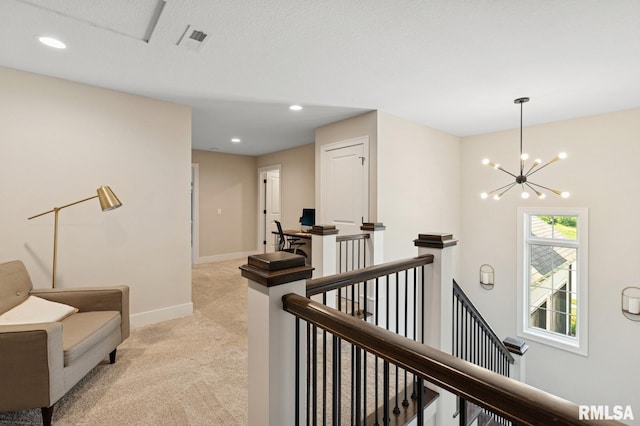 6925 Grover Sta, Bettendorf, IA 52722 - hall with an upstairs landing, light carpet, a chandelier, and recessed lighting